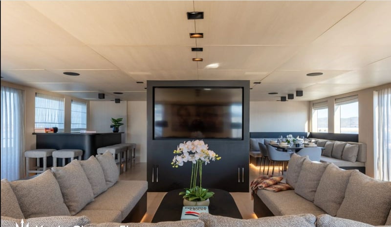 Main salon with bar to one side and dining to the other