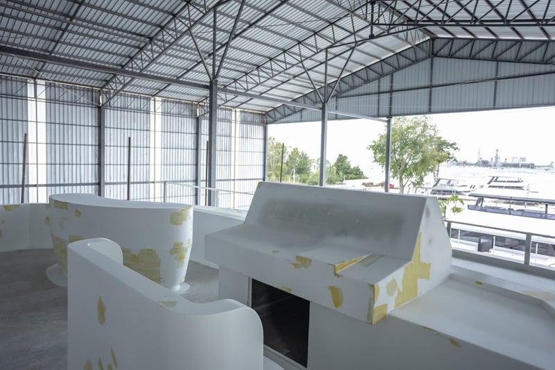 Helm seating with moulded finishes and the marina beyond the shed doors