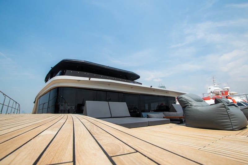 Foredeck lounge with deep sunpads on solid teak.