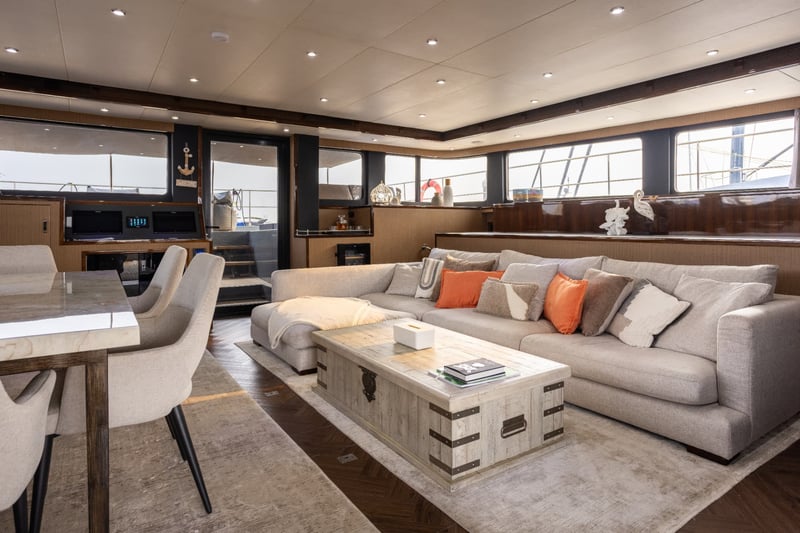 Salon and dining area together, open from the sofa to the aft doors.