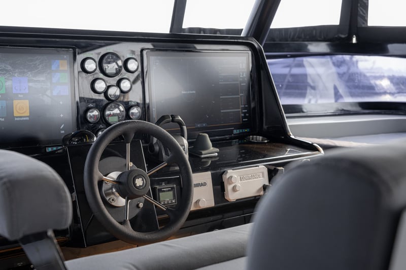 Flybridge helm with twin chart displays and engine controls.