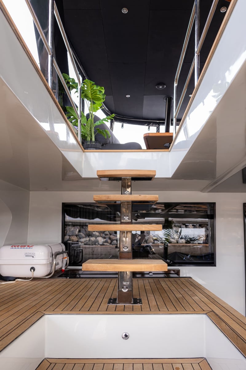 Floating teak stairs lead up from the aft deck to the flybridge.