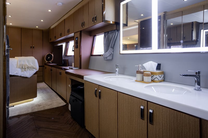 Ensuite vanity with twin basins and a backlit mirror.
