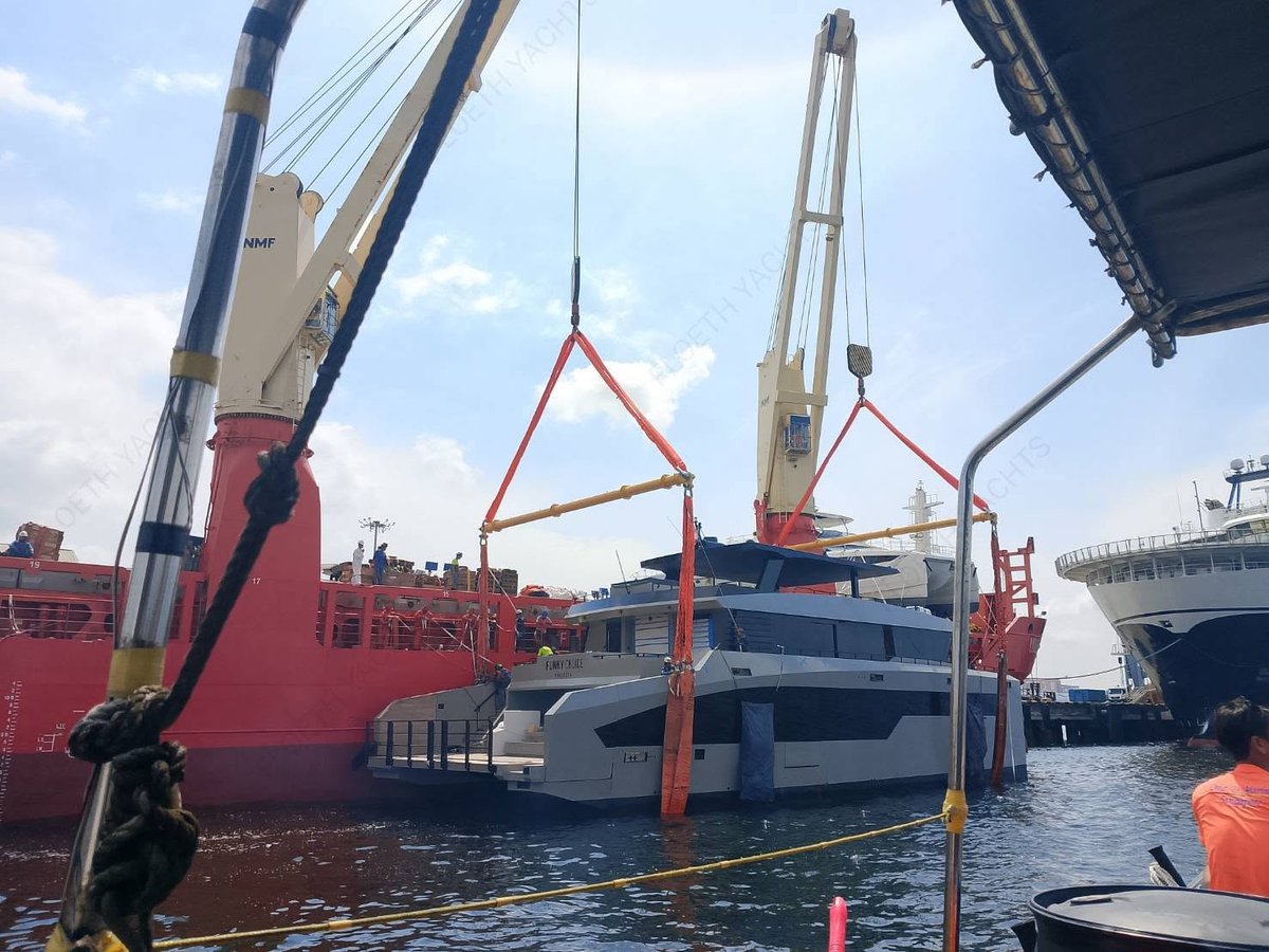 Independence 85 lifted by crane from a cargo ship onto the water in port