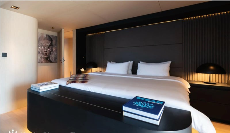 Owner's cabin king bed with dark panelled headboard