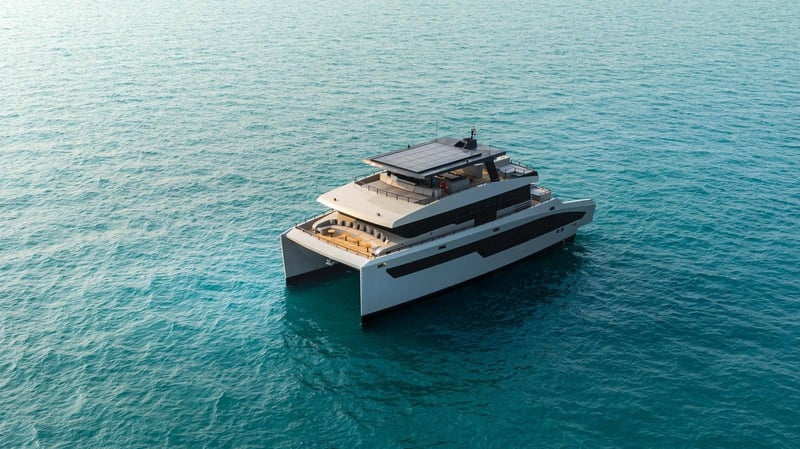 Aerial three-quarter view at sea showing the aft lounge and solar hardtop