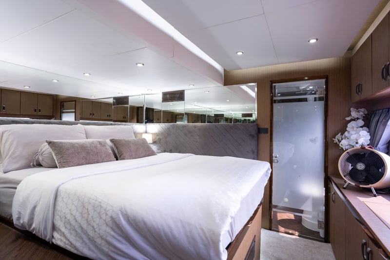 Bright double cabin with an ensuite door and mirrored headboard.