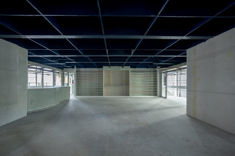 Main salon with built-in shelving and painted overhead under construction