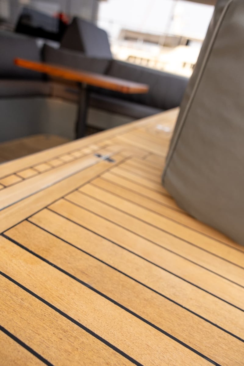 Teak decking with crisp caulking lines throughout.